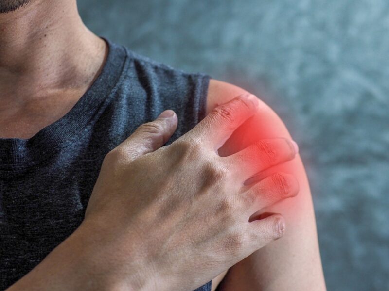 A,Man,Holding,His,Shoulder,In,Pain,Caused,By,Heavy
