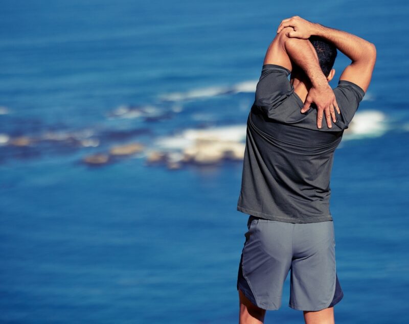 Fitness,,Arms,And,Man,Stretching,By,Ocean,Before,Workout,Or